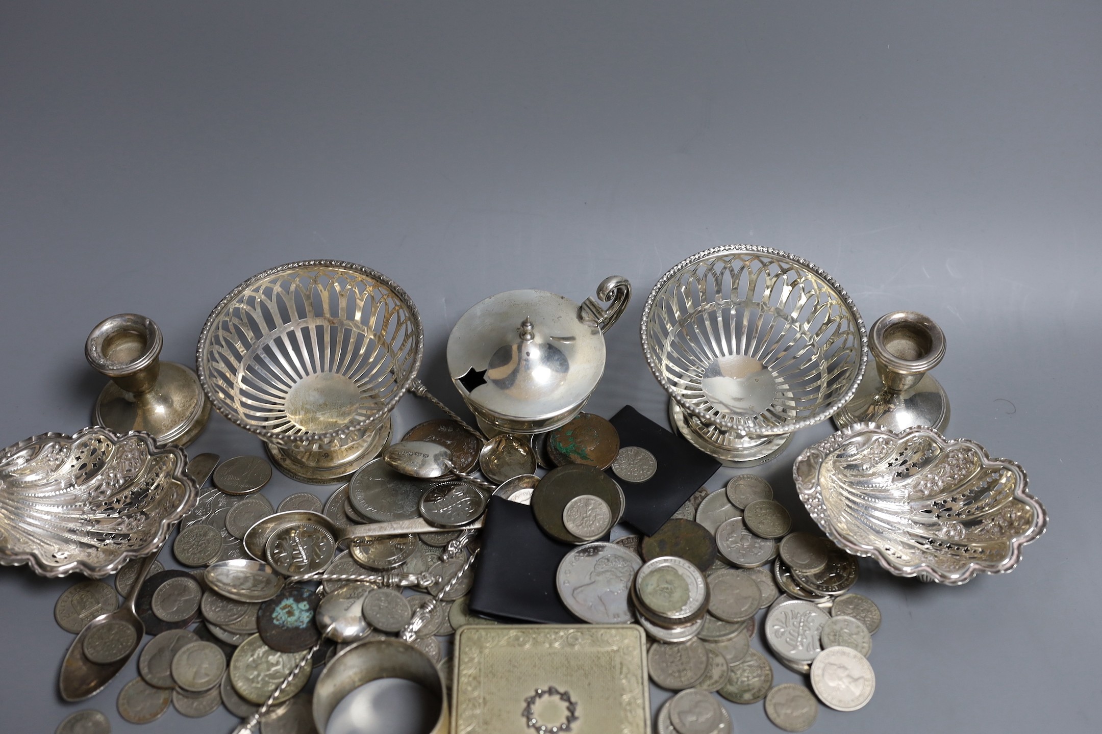 Mixed silver items including a pair of George V pierced silver bowls, weighted, a pair of pierced silver shell dishes, a pair of dwarf candlesticks, a silver napkin ring and other items including compact and assorted coi